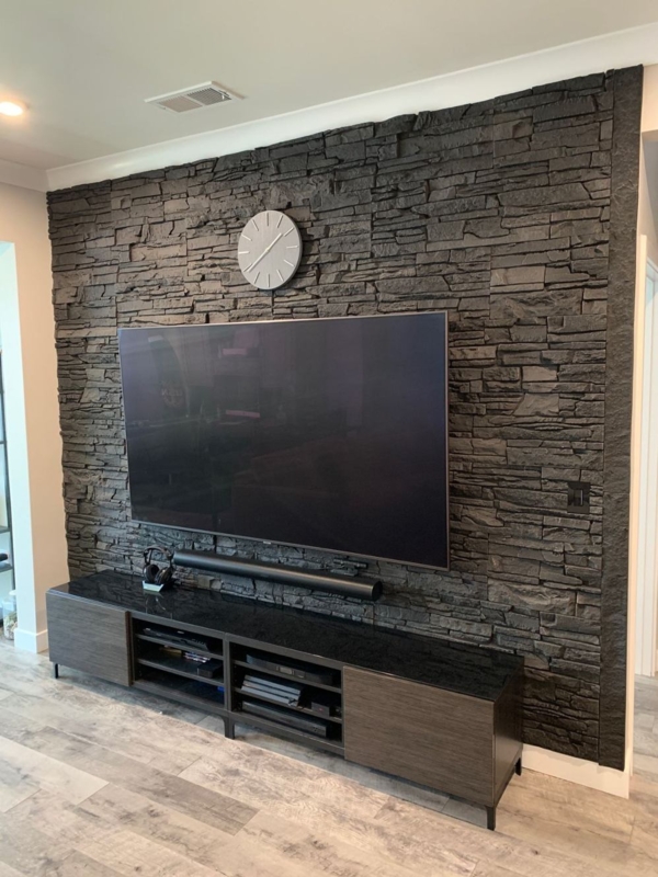 Media Console Two Tone Design against Textured Stacked Stone Wall