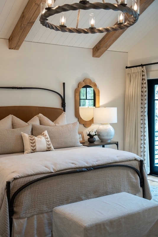 Metal Frame Bed under Exposed Wood Beams in Rustic Modern Bedroom