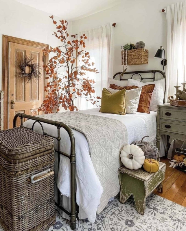 Metal Spindle Bed with Oversized Wicker Trunk and Rustic Fall Decor