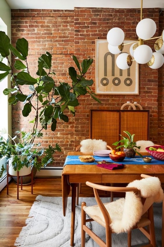 Mid-Century Boho Dining Room: Exposed Brick Wall & Wishbone Chairs