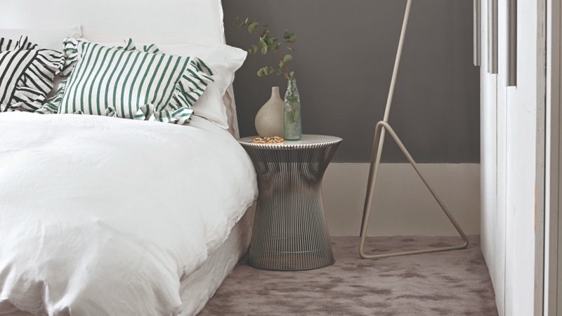 Mid-Century Modern Bedroom with Wire Base Table and Green Striped Pillow
