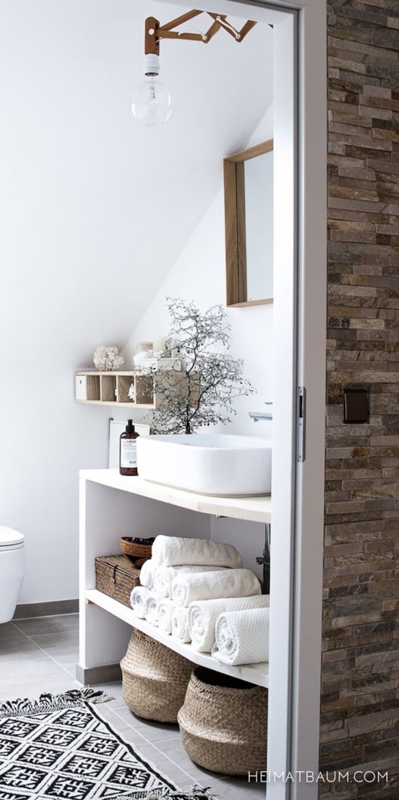 Minimalist Bathroom with Open Shelving and Stacked Stone Accent Wall