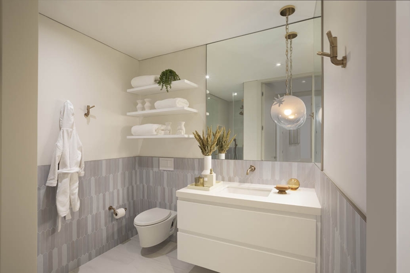 Minimalist Bathroom with Vertical Picket Tile Accent and Gold Hardware