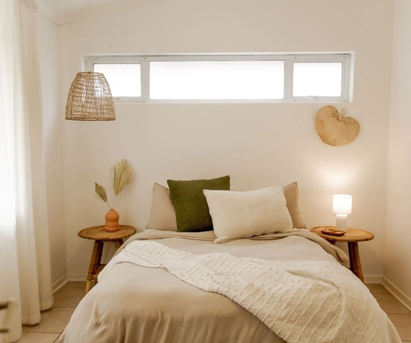 Minimalist Bedroom with Woven Accents and High Clerestory Window Layout