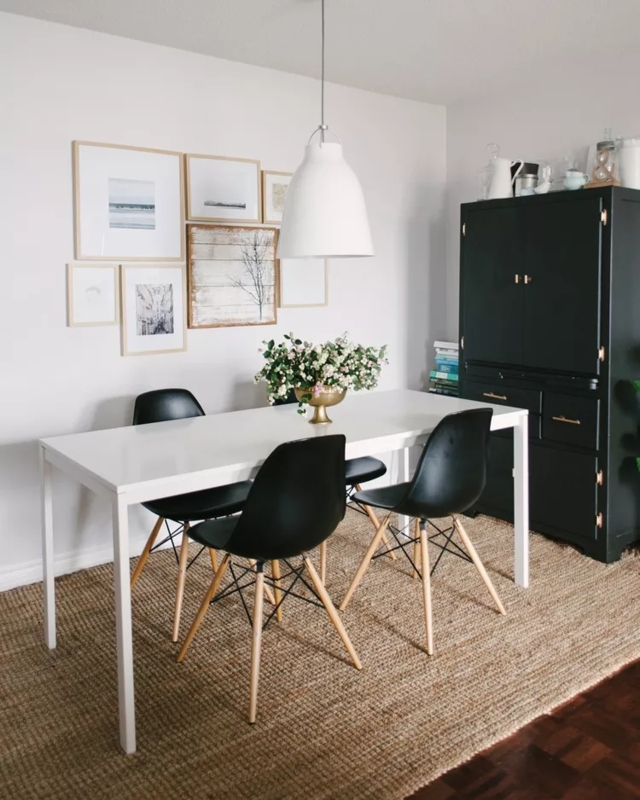 Minimalist Dining: Black Mid-Century Chairs, White Table, Gallery Wall