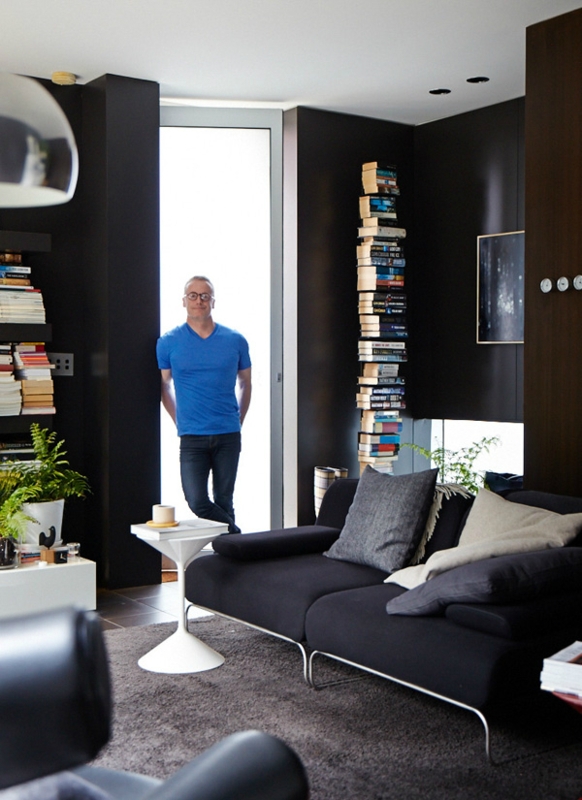 Minimalist Living Room featuring Vertical Book Stack and Dark Walls