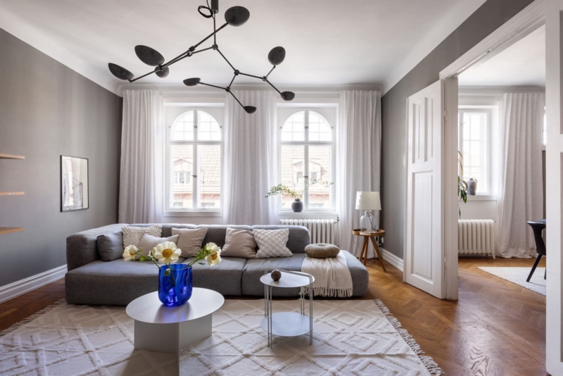 Minimalist Living Room with Low Profile Sectional and Arched Windows
