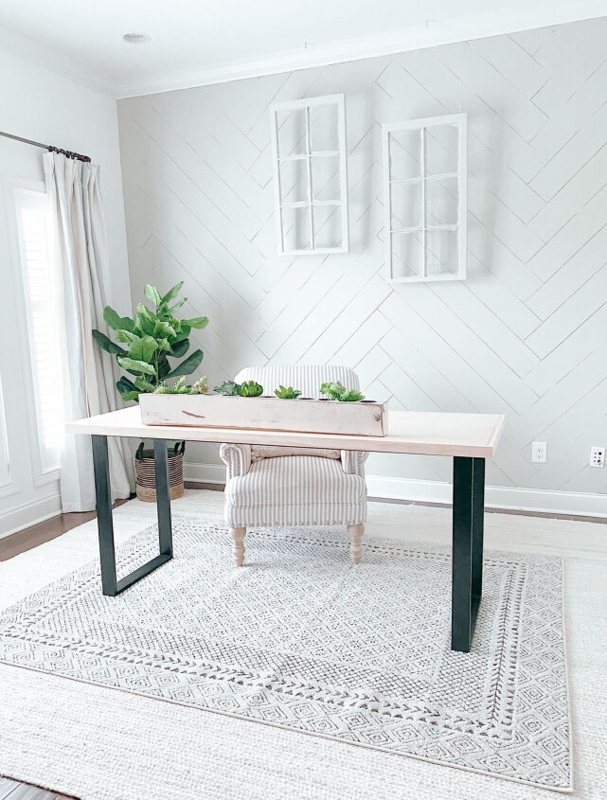 Minimalist Writing Desk with Striped Armchair and Herringbone Wall