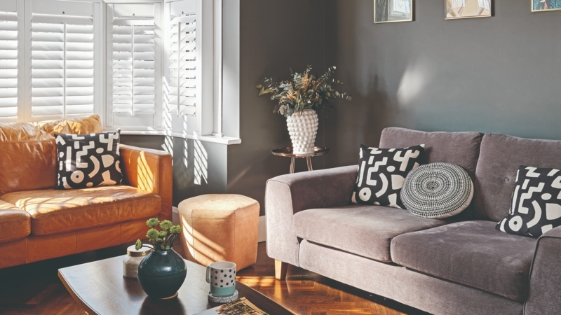 Mixing Leather and Fabric Sofas in Living Room with Plantation Shutters