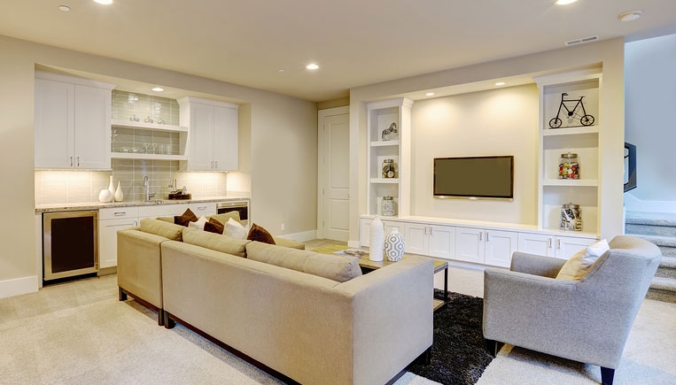 Modern Basement Lounge with Built-In Wet Bar and Integrated Media Wall