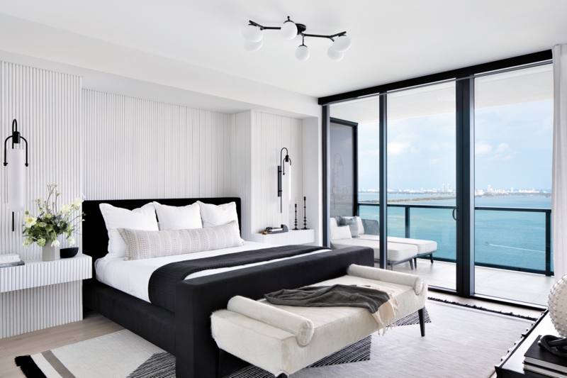 Modern Black Upholstered Bed with Fluted Accent Wall and Coastal View