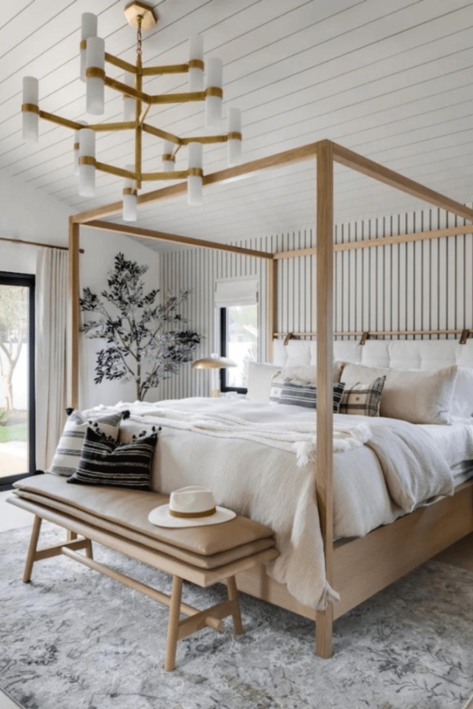 Modern Coastal Bedroom with Vertical Striped Wallpaper and Brass Fixture