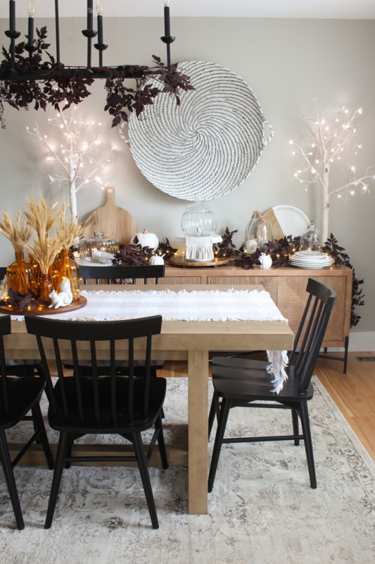 Modern Fall Dining Room with Woven Wall Art & Lit Birch Trees