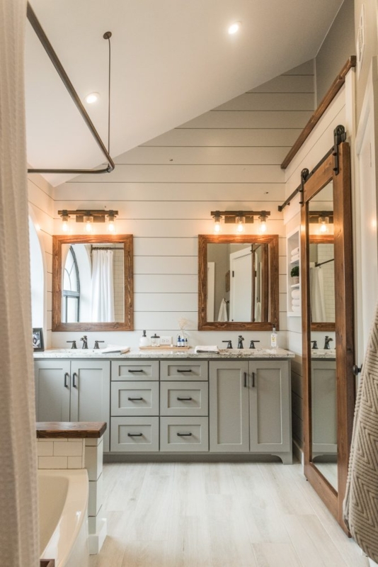 Modern Farmhouse Bathroom featuring Mirrored Barn Door and Shiplap Walls