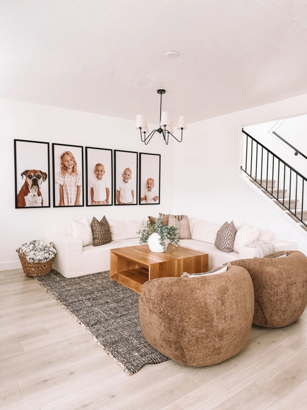 Modern Farmhouse Living Room with Oversized Portrait Gallery and Nubby Chairs