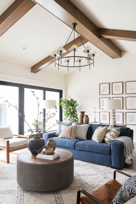 Modern Farmhouse Navy Sofa with Exposed Beams and Geometric Rug