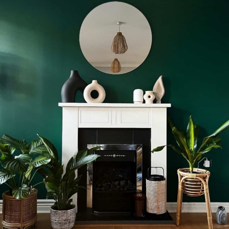 Modern Fireplace Mantel Styling with Sculptural Vases and Green Wall