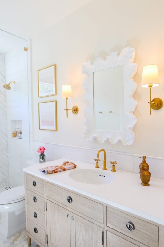 Modern Glam Bathroom Vanity with scalloped white mirror and gold hardware.