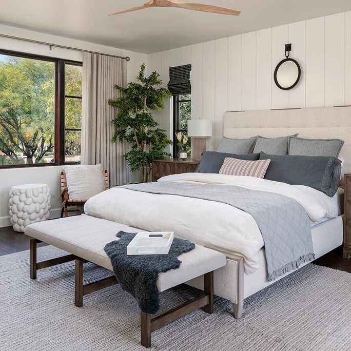 Modern Guest Bedroom with Paneling and Organic Pebble Textured Stool