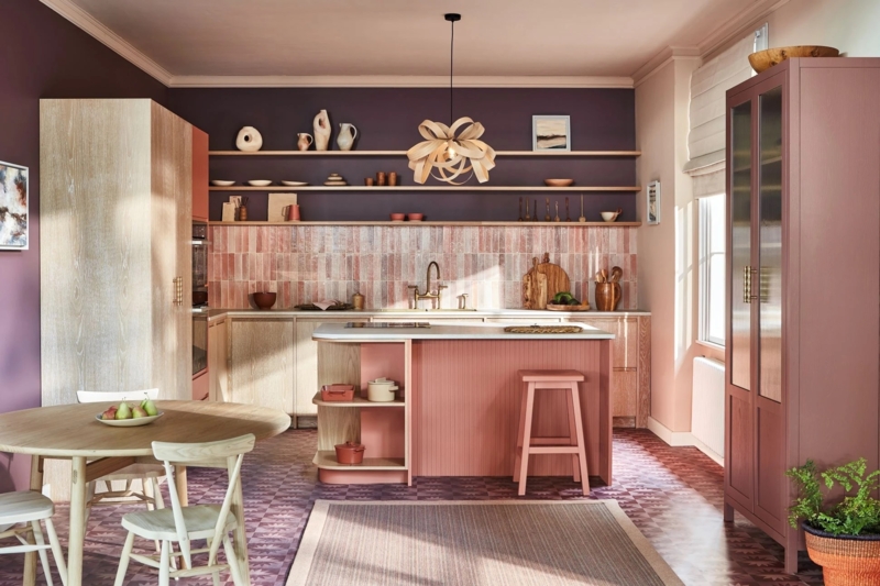 Modern Kitchen with Plum Accent Wall and Ribbed Pink Island Base.