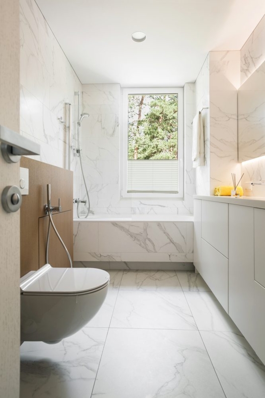 Modern Marble Bathroom Design: Wall-Mounted Toilet and Wood Accent Panel