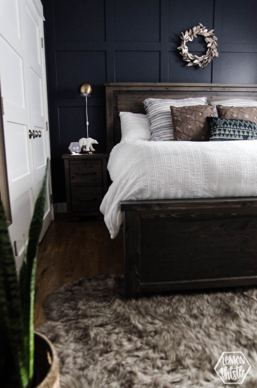 Modern Rustic Bedroom Ideas: Navy Grid Wall and Dark Stained Wood Bed