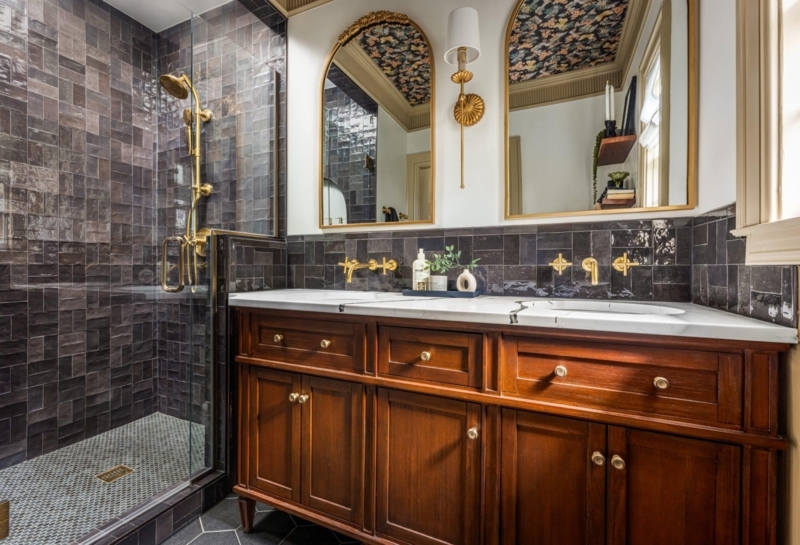 Moody Bathroom featuring Floral Wallpaper on Ceiling and Arched Mirrors