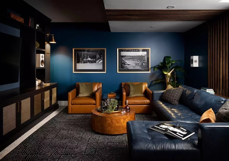 Moody Den Navy Accent Wall with Burl Wood Table and Slatted Ceiling