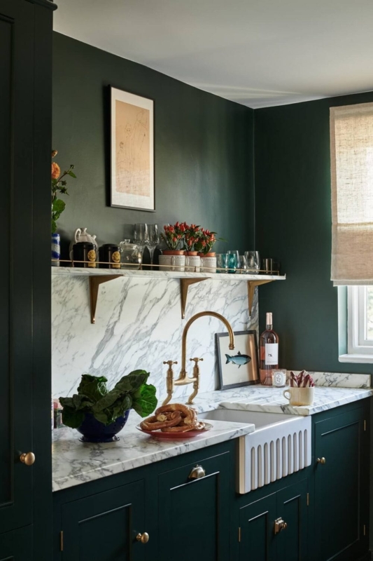 Moody Forest Green Kitchen with Marble Shelf and Fluted Sink.