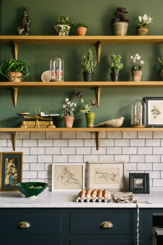 Moody Green Kitchen Walls with Curated Open Shelving and Brass Accents