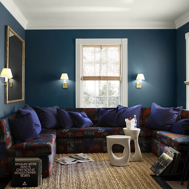 Moody Living Room with Navy Walls and U-Shaped Ikat Sectional Sofa