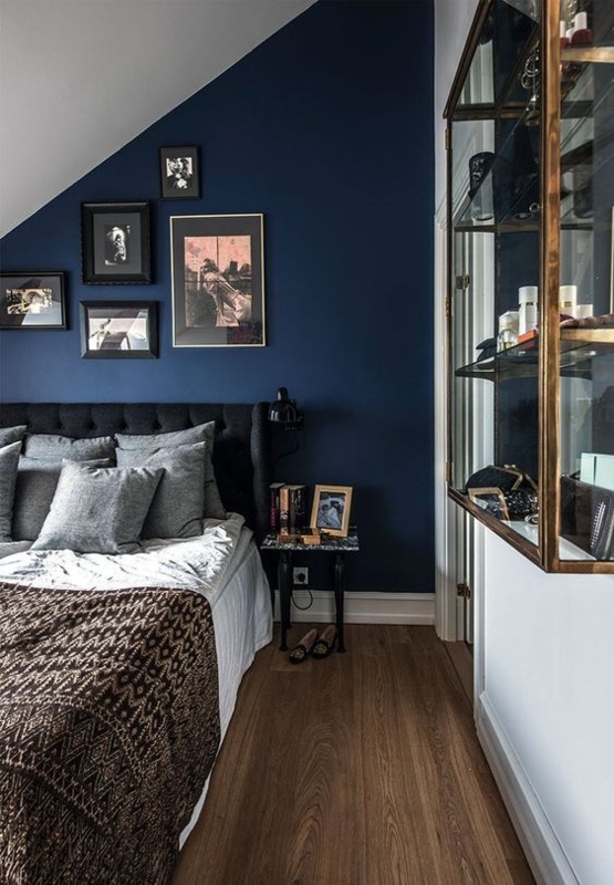 Moody Upholstered Bed under Sloped Ceiling with Gallery Wall