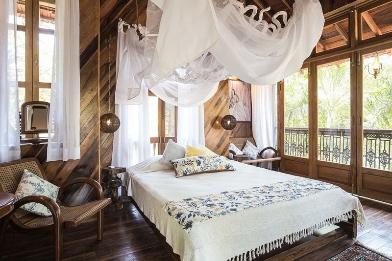 Mosquito Net Canopy and Diagonal Wood Paneling in a Tropical Bedroom