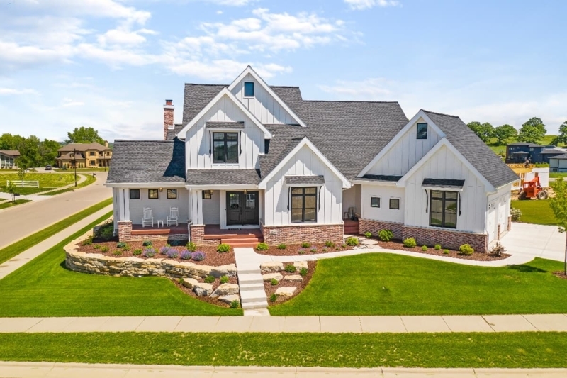 Multi-Gabled Home Exterior: White Siding and Brick Foundation