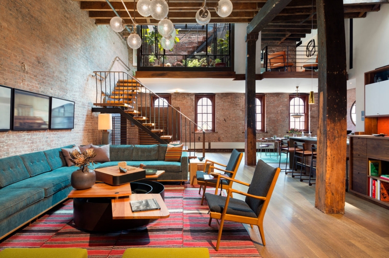 Multi-Level Industrial Loft Living Room: Tiered Wood Coffee Table, Teal Sectional