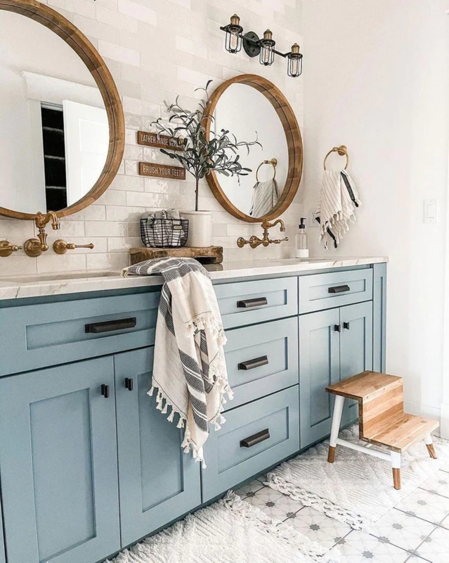 Muted Blue Double Vanity in Farmhouse Bathroom with Brushed Gold Hardware