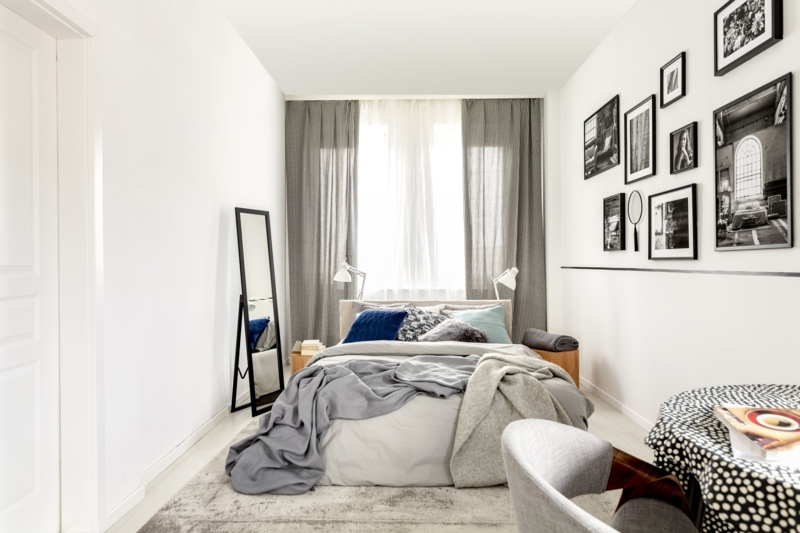 Narrow Bedroom Layout with Floor-to-Ceiling Gallery Wall