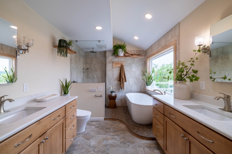 Natural Stone Tile Bathroom with Dual Wood Vanities