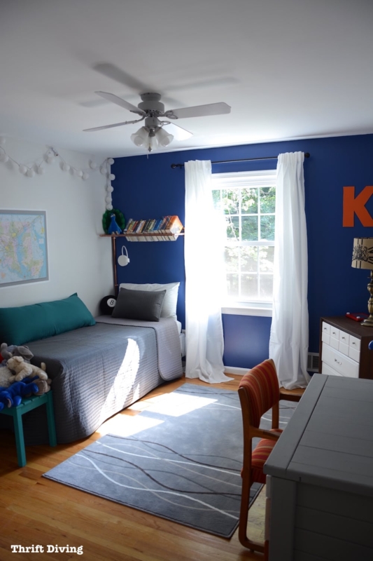Navy Accent Wall Bedroom with Industrial Pipe Shelving for Kids