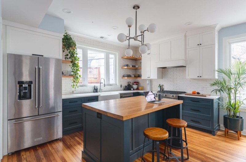 Navy and White Kitchen Cabinets with a Wood Island Top