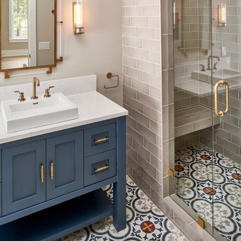 Navy Blue Bathroom Vanity with Gold Fixtures & Patterned Floor