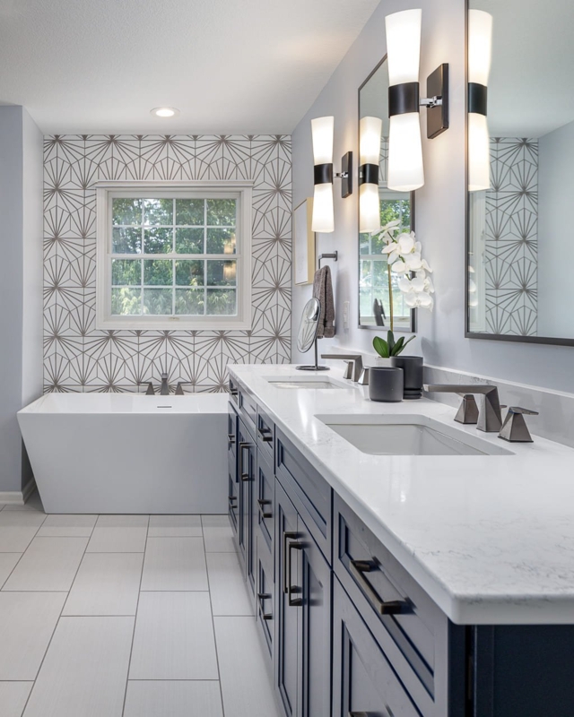 Navy Cabinetry Bathroom with Geometric Accent Wall and Sconces