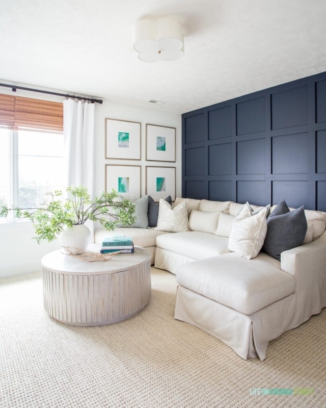 Navy Grid Accent Wall Den with Round Fluted Coffee Table Styling
