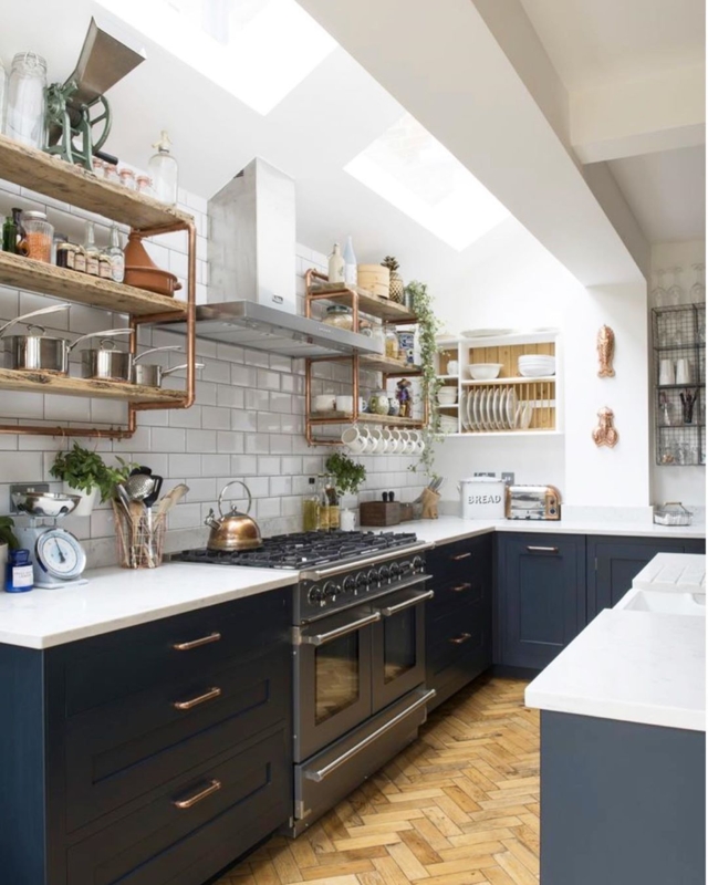 Navy Kitchen Cabinets with Industrial Open Shelving and Copper Pipes