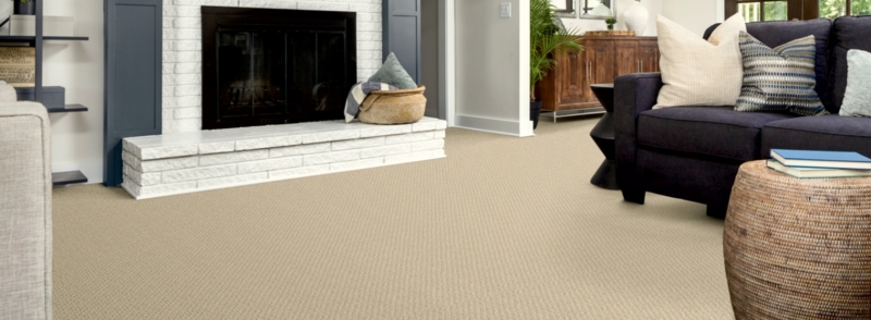 Navy Sofa with Beige Flooring: Textured Loop Pile Broadloom Carpet