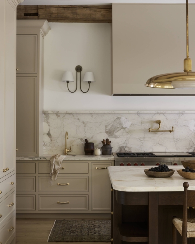Neutral Kitchen with Taupe Cabinets and Full Marble Slab Backsplash.