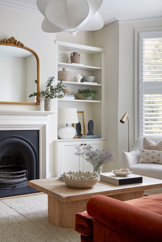 Neutral Living Room with Black Fireplace and Rust Velvet Sofa