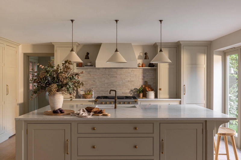 Neutral Taupe Kitchen Cabinets with Textured Stone Tile Backsplash.