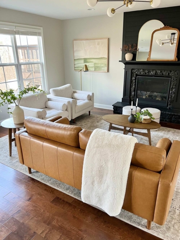 Off-White Accent Chairs Paired with a Tan Leather Sofa
