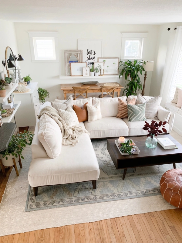 Off-White Sectional Sofa with Layered Area Rugs in Boho Living Room Layout